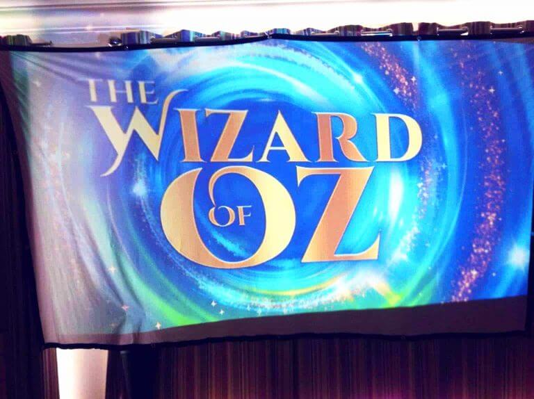 A vibrant banner displaying "the wizard of oz"