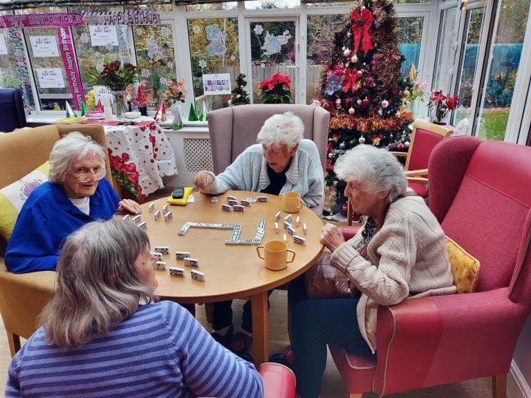 an elderly woman playing a board game