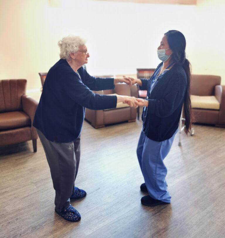 two women joyfully dancing together