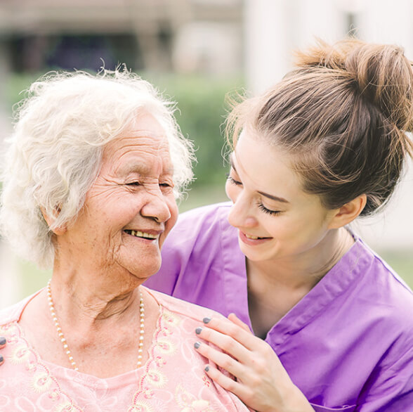 A caretaker and an elderly woman are in a Haslemere care home