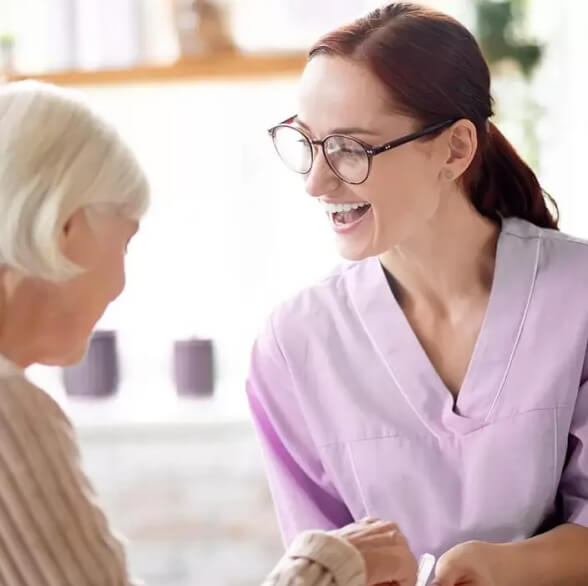 A young female nurse with an elderly woman