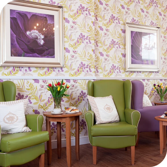 A cozy sitting area in Hamilton Nursing Home with floral wallpaper