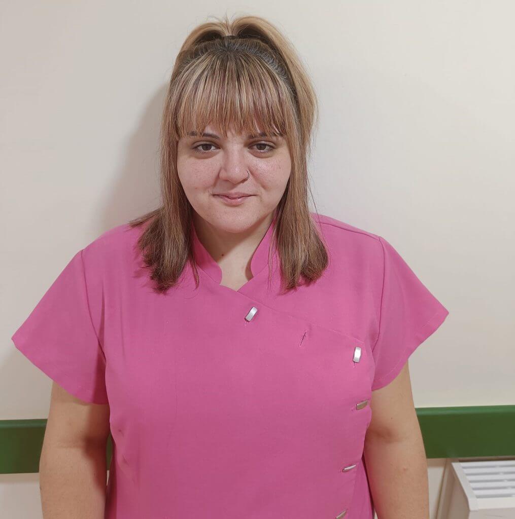 A woman in a pink medical scrub