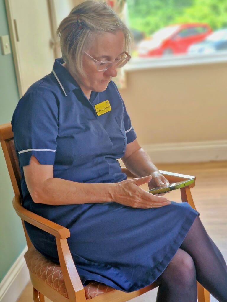 A female nurse in a blue uniform