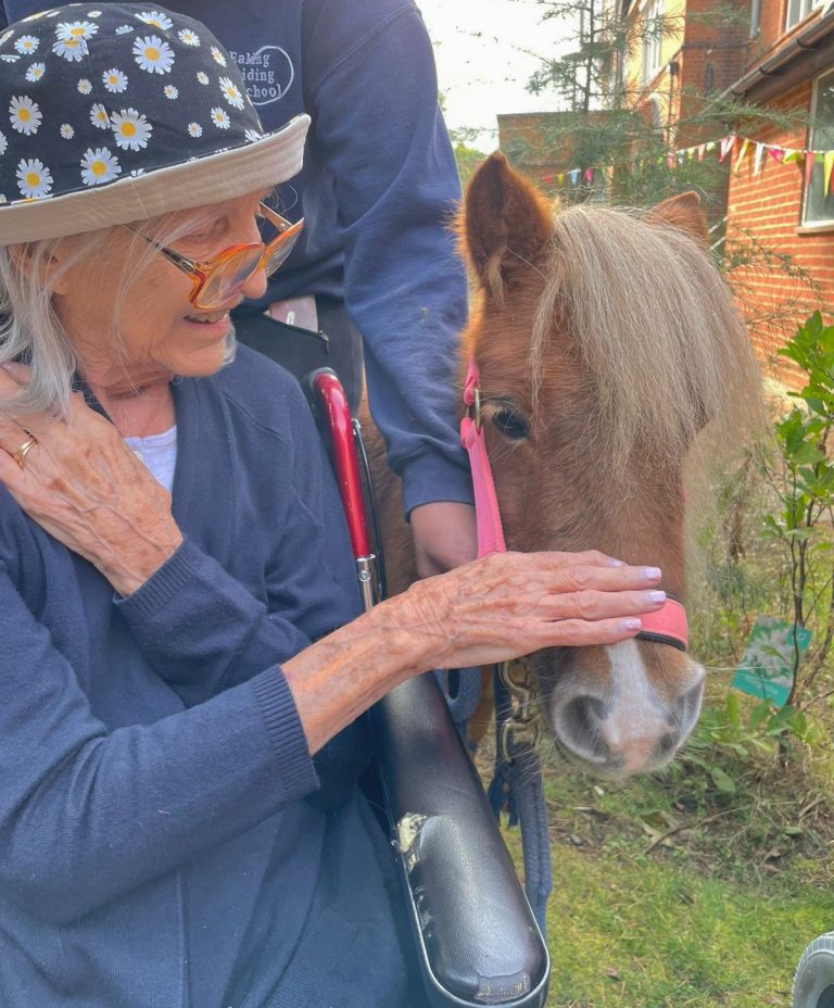 elderly woman with a horse